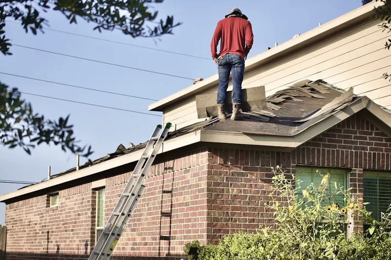 Professional roofer working on a residential roof in Vista East